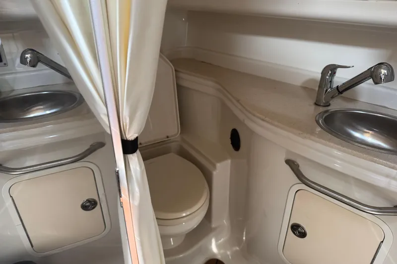 Slide: The Image of 2008 Sea Ray 340 Sundancer bathroom with dual sinks and toilet. - 14