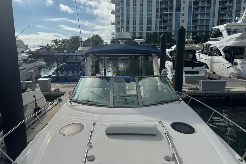 Slide: The Image of 2008 Sea Ray 340 Sundancer docked at marina with modern buildings in background. - 17