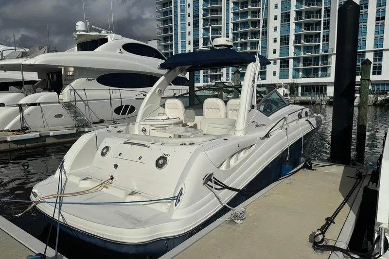 Slide: The Image of 2008 Sea Ray 340 Sundancer docked at marina with modern buildings in background. - 3