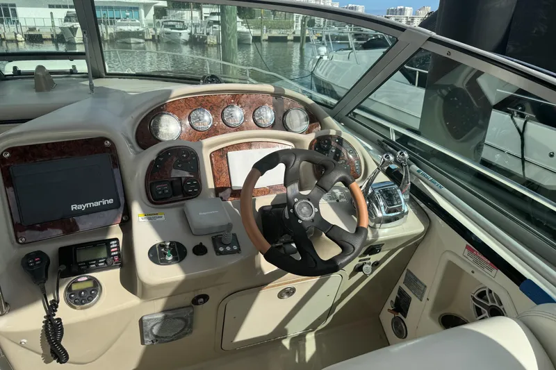 Slide: The Image of Cockpit of 2008 Sea Ray 340 Sundancer with steering wheel and navigation controls. - 5