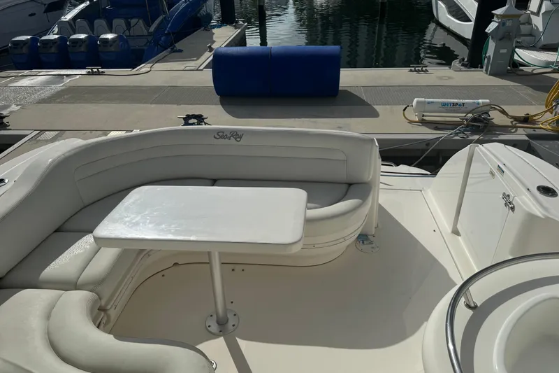 Slide: The Image of 2008 Sea Ray 340 Sundancer boat interior with white seating and table at marina. - 8