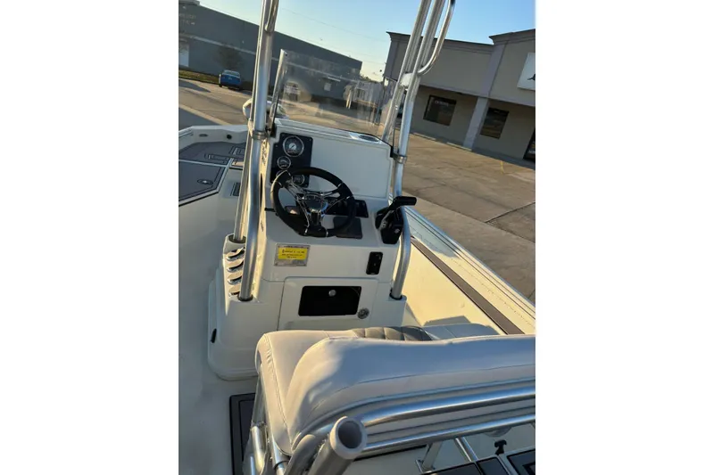 Slide: The Image of 2026 Excel 220 Bay Pro Elite boat interior with steering console and seating. - 14