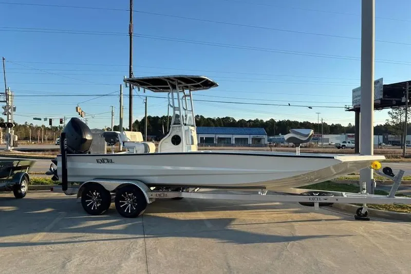 The Image of 2026 Excel 220 Bay Pro Elite boat on trailer, parked outdoors under clear sky. - 9