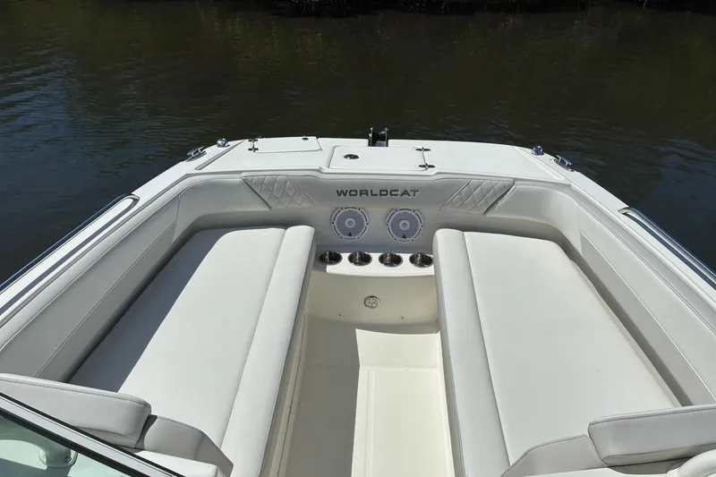 Slide: The Image of 2025 World Cat 230 SD boat interior with white seating and cup holders. - 13