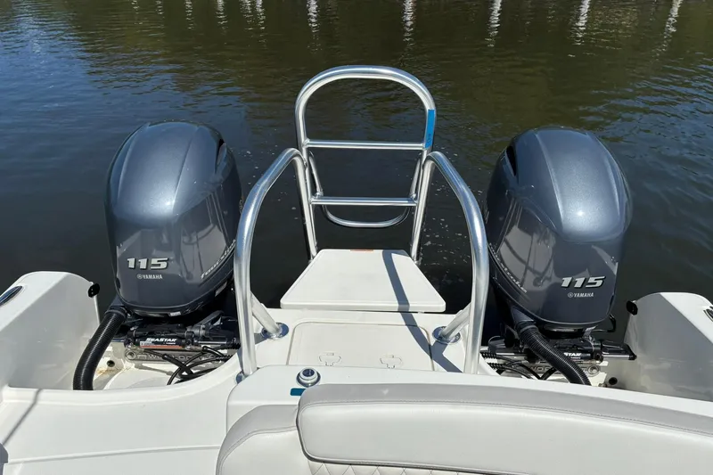 Slide: The Image of 2025 World Cat 230 SD boat with twin Yamaha 115 engines on water. - 7