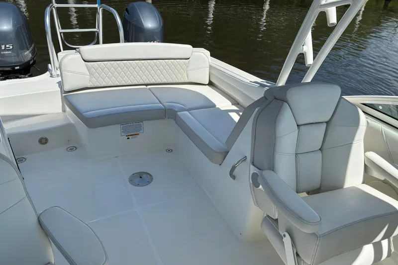Slide: The Image of 2025 World Cat 230 SD boat interior with plush seating and dual engines. - 9