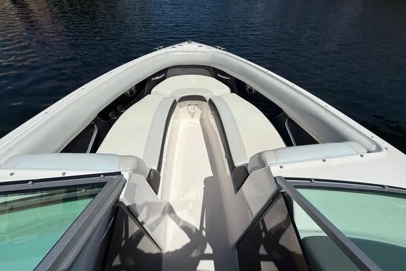 Slide: The Image of 2014 Regal 2500 Bowrider boat interior with open bow seating on water. - 5