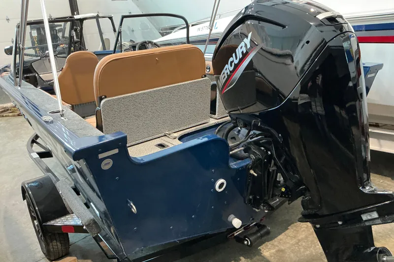 Slide: The Image of 2026 Starweld 16 SXT boat with Mercury outboard motor in a showroom. - 8
