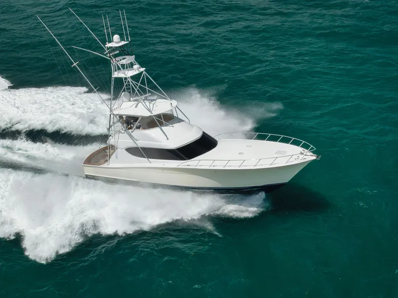 The Image of 2009 Hatteras 60GT yacht cruising swiftly on turquoise ocean waters. - 1