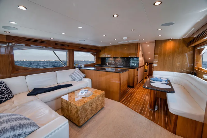 Slide: The Image of Luxurious interior of 2009 Hatteras 60GT yacht with elegant seating and modern kitchen. - 10