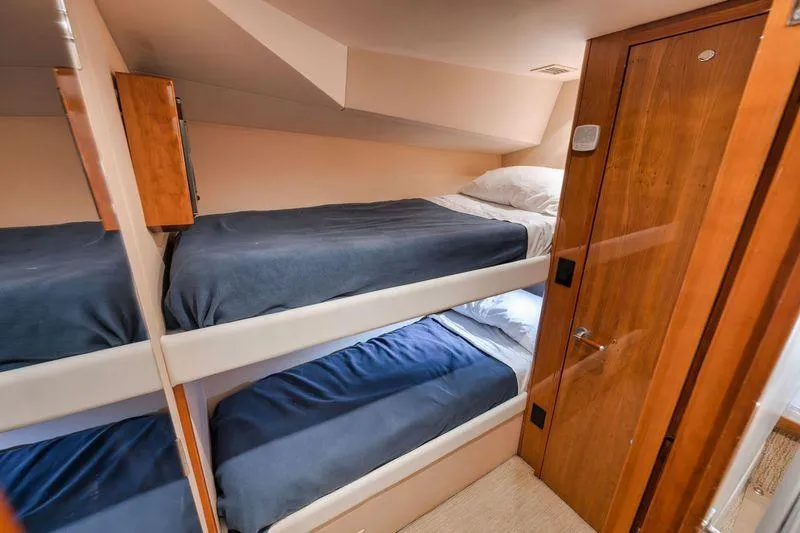 Slide: The Image of Interior of 2009 Hatteras 60GT yacht with cozy bunk beds and wooden finishes. - 20