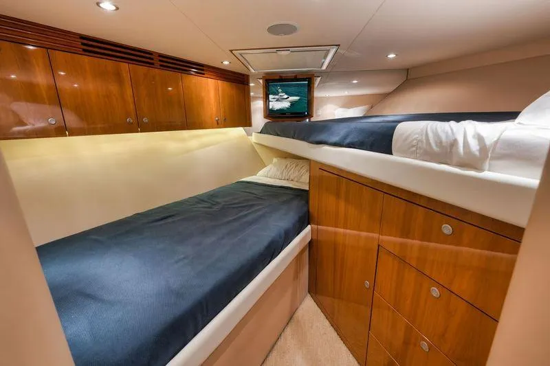Slide: The Image of Interior cabin of 2009 Hatteras 60GT yacht with wooden cabinets and twin beds. - 21