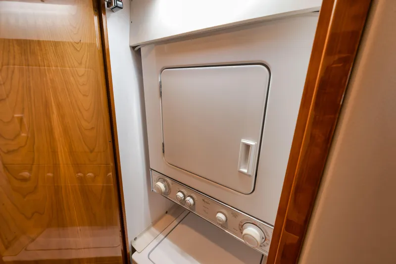 Slide: The Image of Laundry area inside 2009 Hatteras 60GT yacht with stacked washer and dryer. - 22
