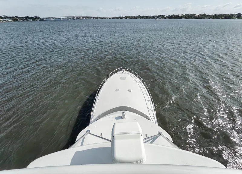 Slide: The Image of Bow view of 2009 Hatteras 60GT yacht cruising on open water. - 26