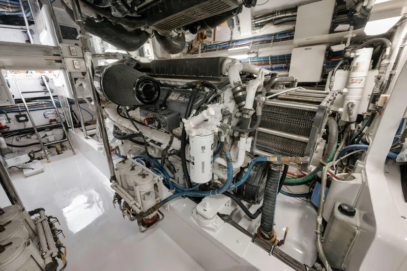 Slide: The Image of Engine room of 2009 Hatteras 60GT yacht, showcasing complex machinery and components. - 48