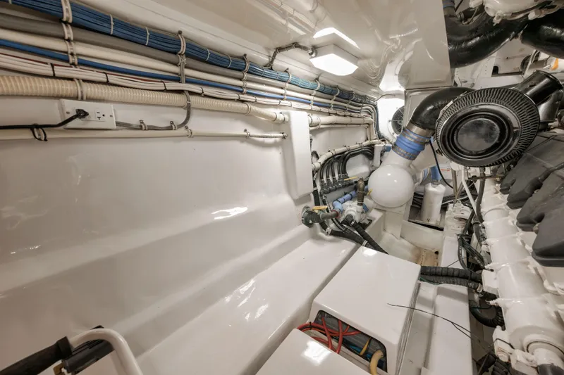 Slide: The Image of Engine room of 2009 Hatteras 60GT yacht, showcasing clean layout and wiring. - 49