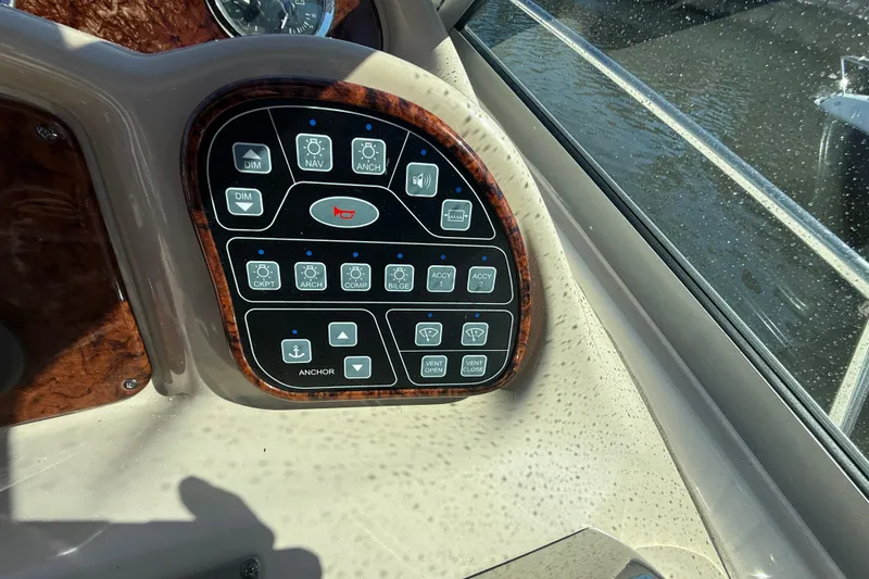 Slide: The Image of Control panel of a 2003 Sea Ray 320 Sundancer boat, featuring various function buttons. - 17