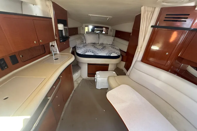 Slide: The Image of Interior of 2003 Sea Ray 320 Sundancer yacht with cozy cabin and kitchenette. - 28