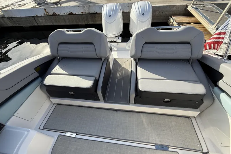 Slide: The Image of 2024 Regal LX9 boat interior with dual seats and American flag. - 13