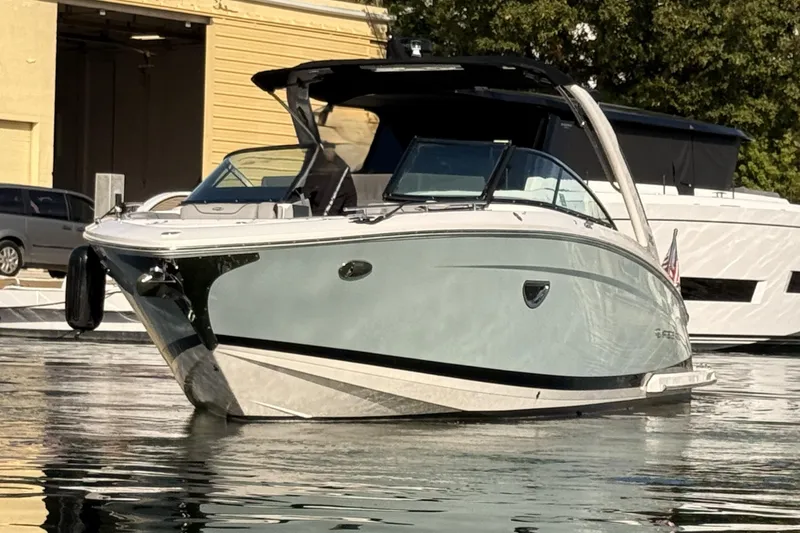 Slide: The Image of 2024 Regal LX9 boat docked on calm water, showcasing sleek design and modern features. - 2