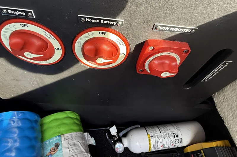 Slide: The Image of Control panel with red switches for engine, house battery, and bow thruster on a 2024 Regal LX9. - 20