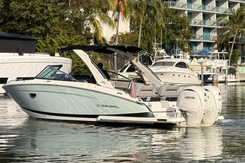 Slide: The Image of 2024 Regal LX9 boat with Yamaha engines docked in a marina. - 5