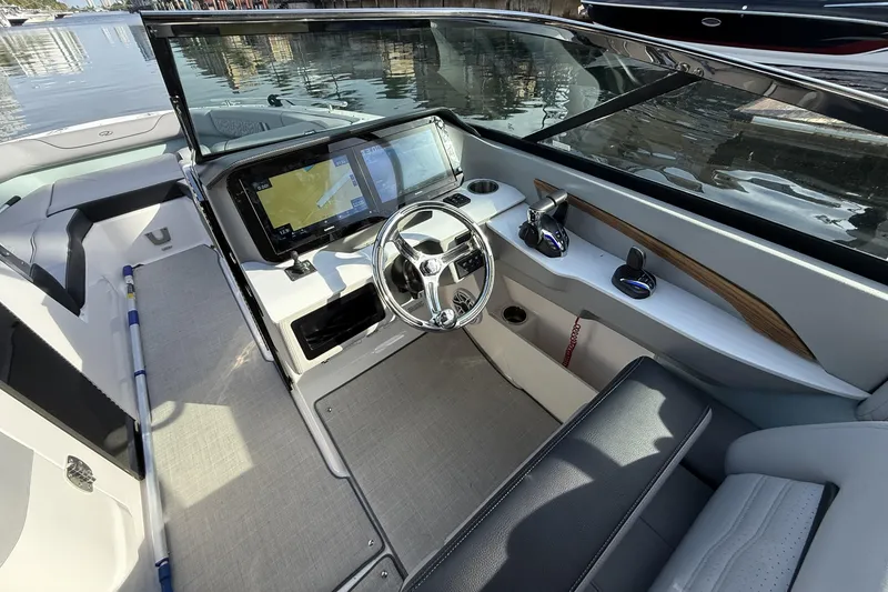 Slide: The Image of 2024 Regal LX9 boat cockpit with modern steering and navigation system. - 9