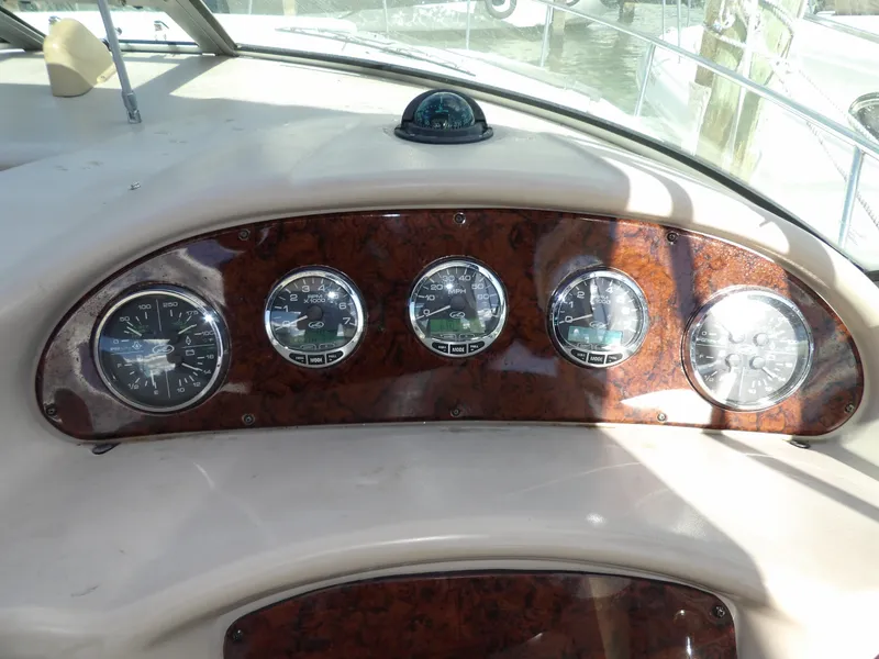Slide: The Image of Dashboard of 2004 Sea Ray 320 Sundancer with gauges and compass. - 20