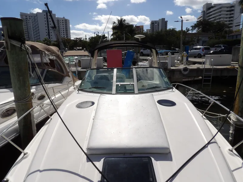 Slide: The Image of 2004 Sea Ray 320 Sundancer docked at marina under sunny skies. - 3