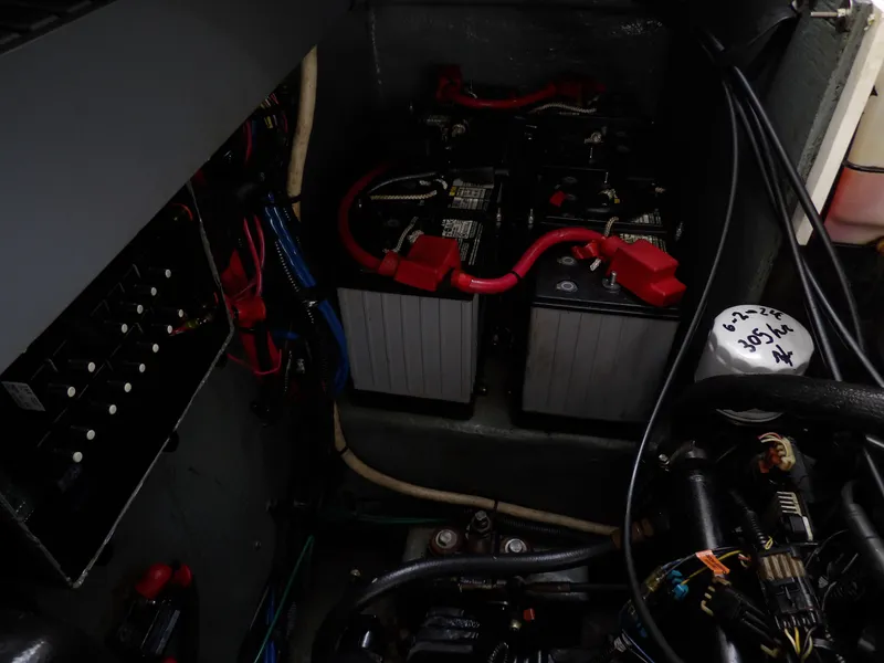 Slide: The Image of Engine compartment of a 2004 Sea Ray 320 Sundancer with visible batteries and wiring. - 30