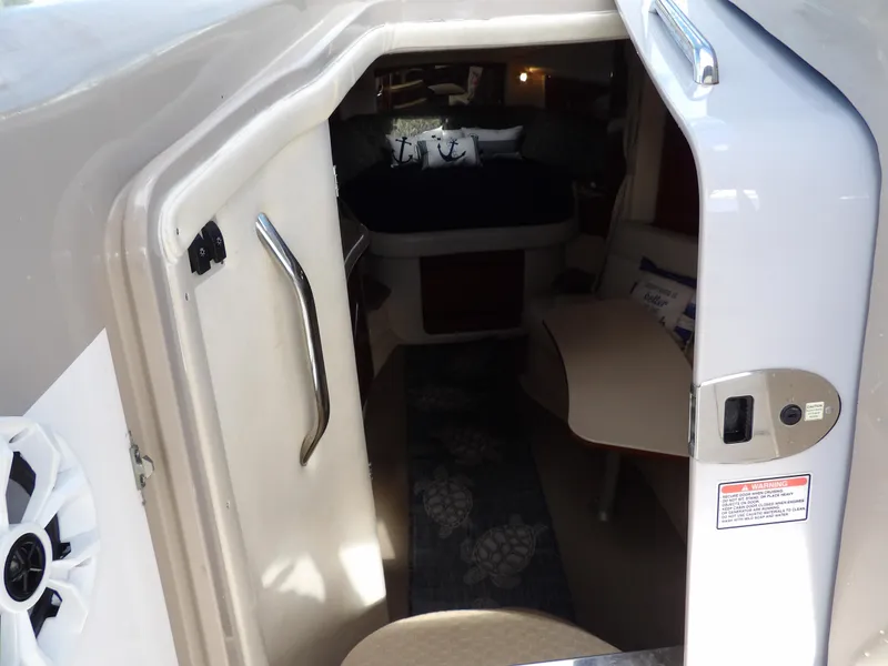 Slide: The Image of Interior view of 2004 Sea Ray 320 Sundancer cabin with seating and bed. - 33