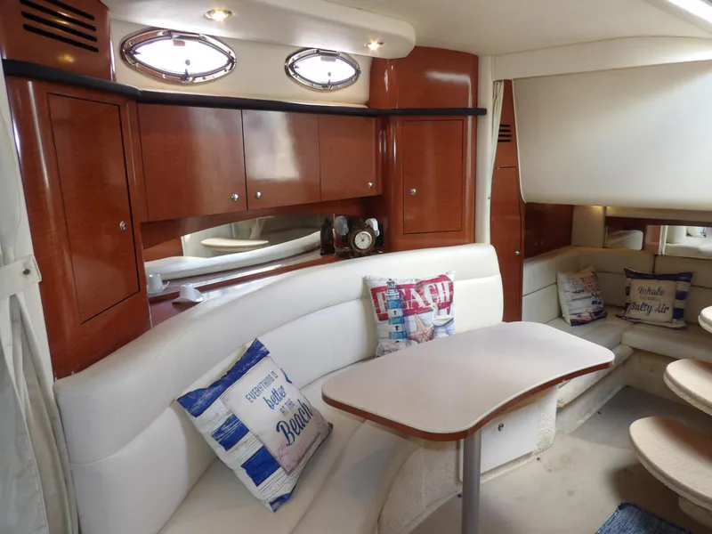 Slide: The Image of Luxurious 2004 Sea Ray 320 Sundancer cabin with elegant wood cabinetry and cozy seating. - 44