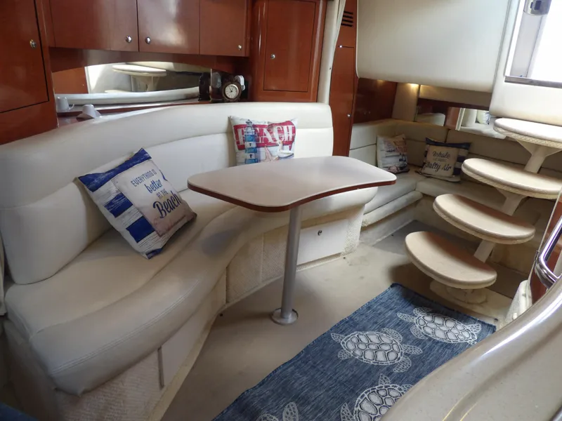 Slide: The Image of Luxurious interior of 2004 Sea Ray 320 Sundancer yacht with cozy seating and nautical decor. - 45