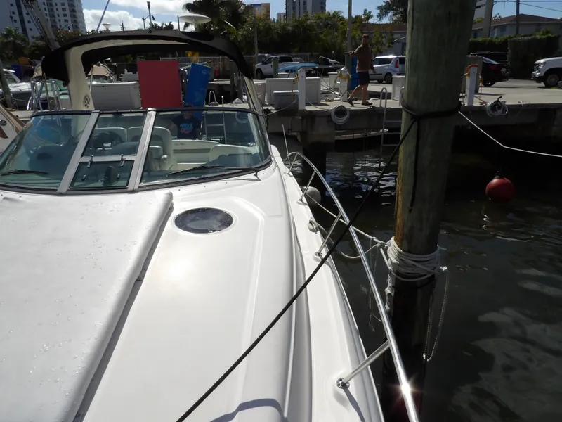 Slide: The Image of 2004 Sea Ray 320 Sundancer docked at marina, sunny day, calm waters. - 7