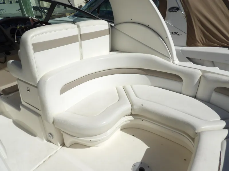 Slide: The Image of Interior seating of 2004 Sea Ray 320 Sundancer boat, featuring white leather upholstery. - 9