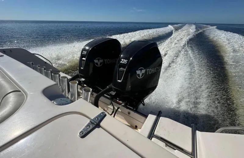 Slide: The Image of 2003 Grady-White Marlin 300 with dual Tohatsu engines cruising on open water. - 10