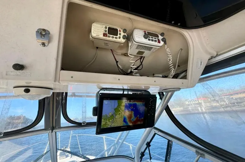 Slide: The Image of 2003 Grady-White Marlin 300 boat cockpit with navigation equipment and radios. - 14