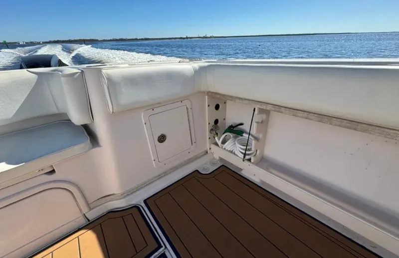 Slide: The Image of 2003 Grady-White Marlin 300 boat interior with cushioned seating and ocean view. - 25