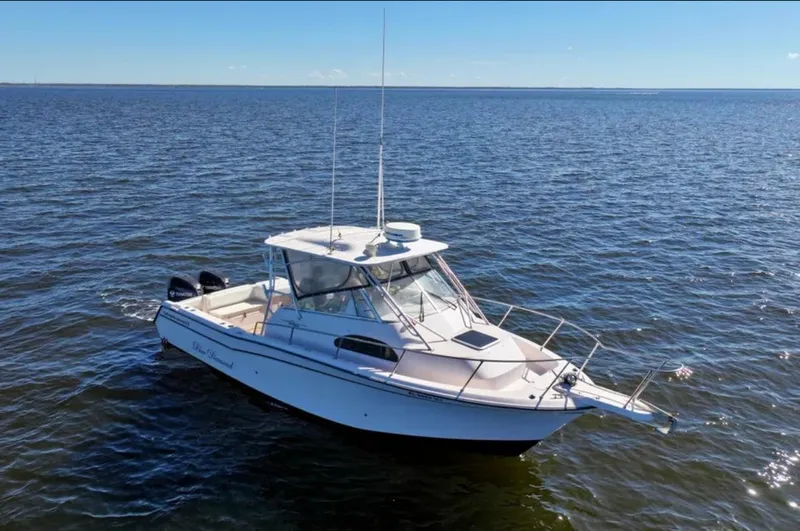Slide: The Image of 2003 Grady-White Marlin 300 boat on open water under clear blue sky. - 3