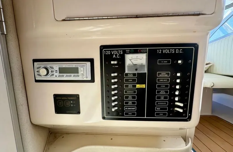 Slide: The Image of Control panel of a 2003 Grady-White Marlin 300 boat, featuring AC and DC switches. - 35