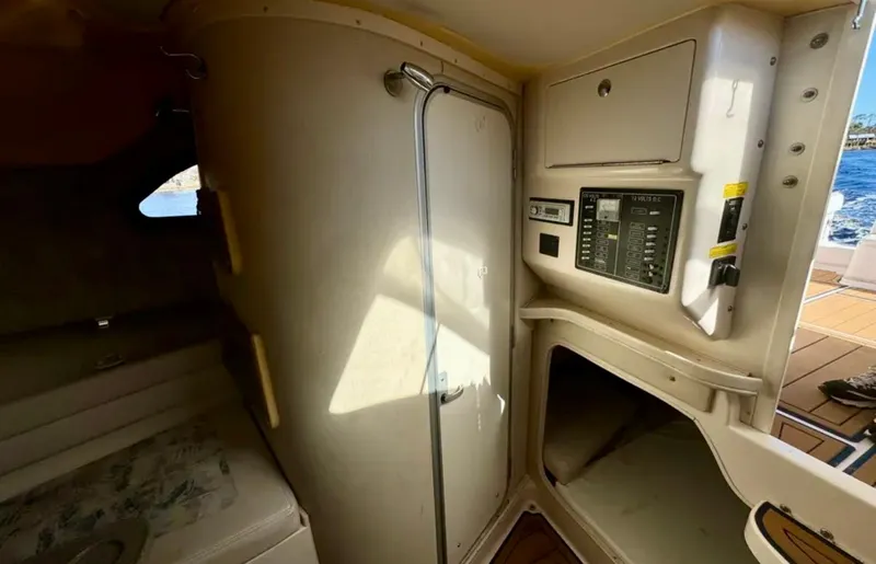 Slide: The Image of 2003 Grady-White Marlin 300 cabin interior with control panel and seating area. - 38