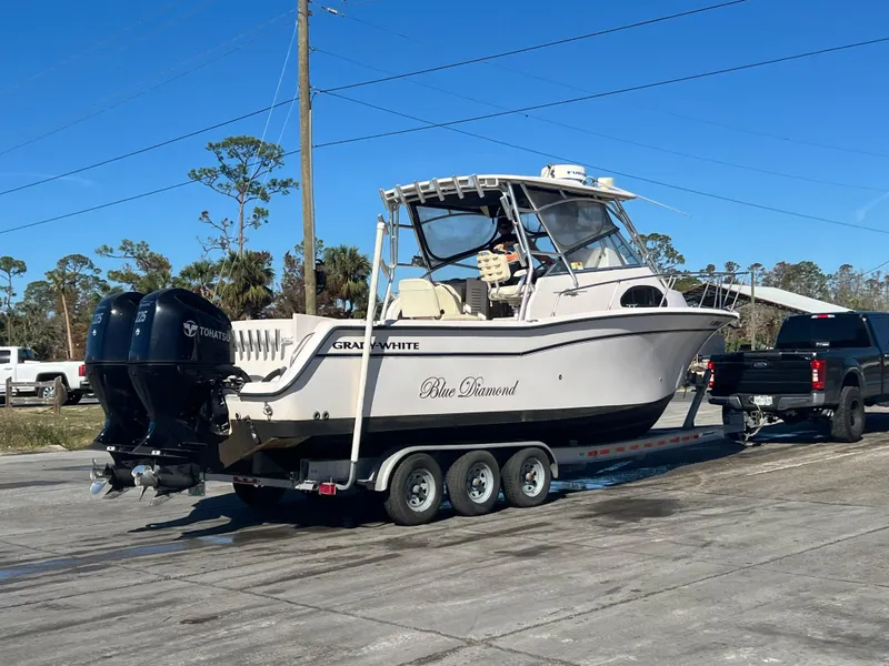 Slide: The Image of 2003 Grady-White Marlin 300 boat on trailer, parked outdoors, clear sky. - 40