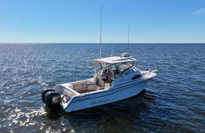Slide: The Image of 2003 Grady-White Marlin 300 boat cruising on open water under clear blue skies. - 5