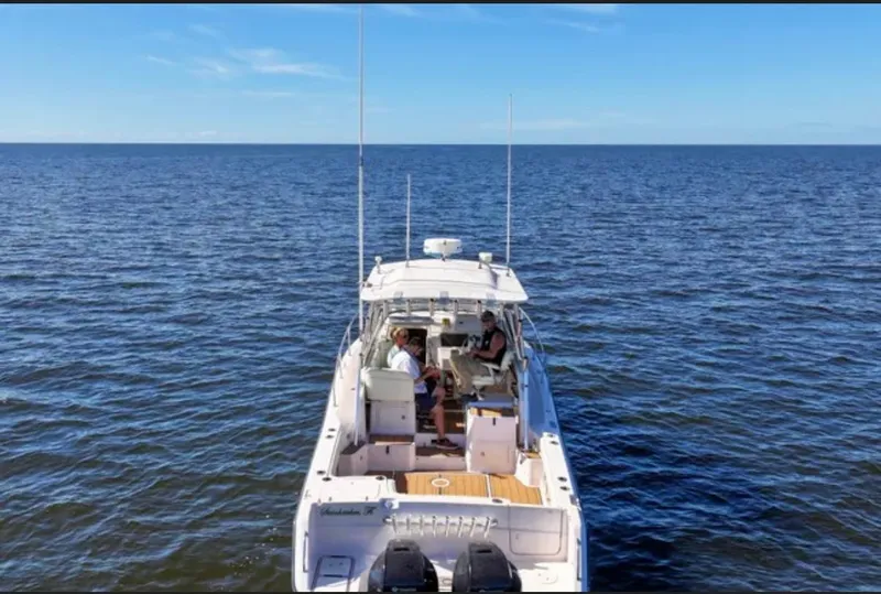 Slide: The Image of 2003 Grady-White Marlin 300 boat on open water, viewed from the rear. - 6