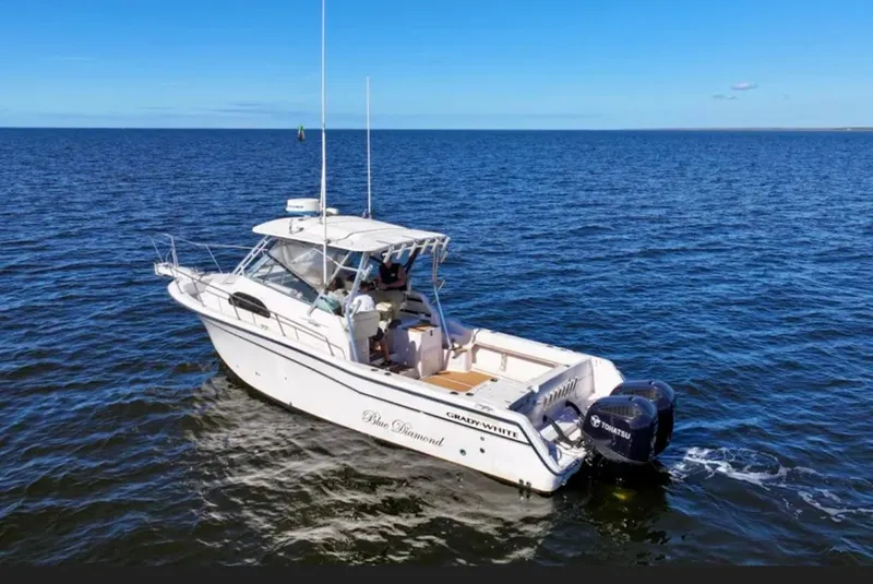 Slide: The Image of 2003 Grady-White Marlin 300 boat cruising on open water under clear blue sky. - 7