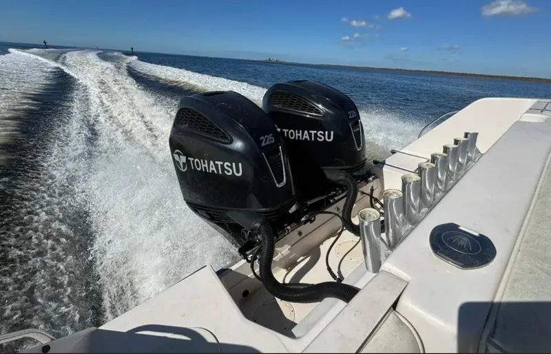 Slide: The Image of 2003 Grady-White Marlin 300 with dual Tohatsu engines cruising on open water. - 8