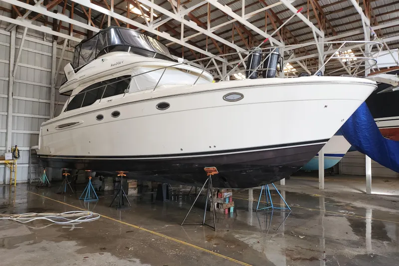 The Image of 2004 Meridian 411 Sedan yacht in dry dock, showcasing sleek design and sturdy construction. - 0