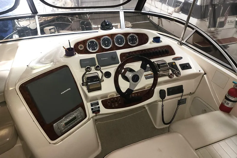 Slide: The Image of Cockpit of a 2004 Meridian 411 Sedan yacht with steering wheel and control panel. - 10