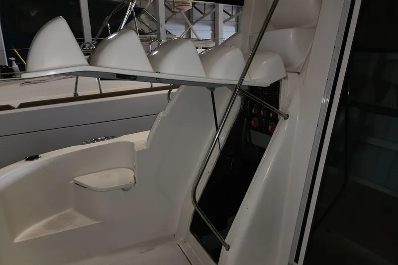 Slide: The Image of Interior view of a 2004 Meridian 411 Sedan boat, showcasing seating and control panel. - 16