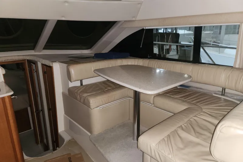 Slide: The Image of Interior of 2004 Meridian 411 Sedan yacht with beige seating and table. - 18